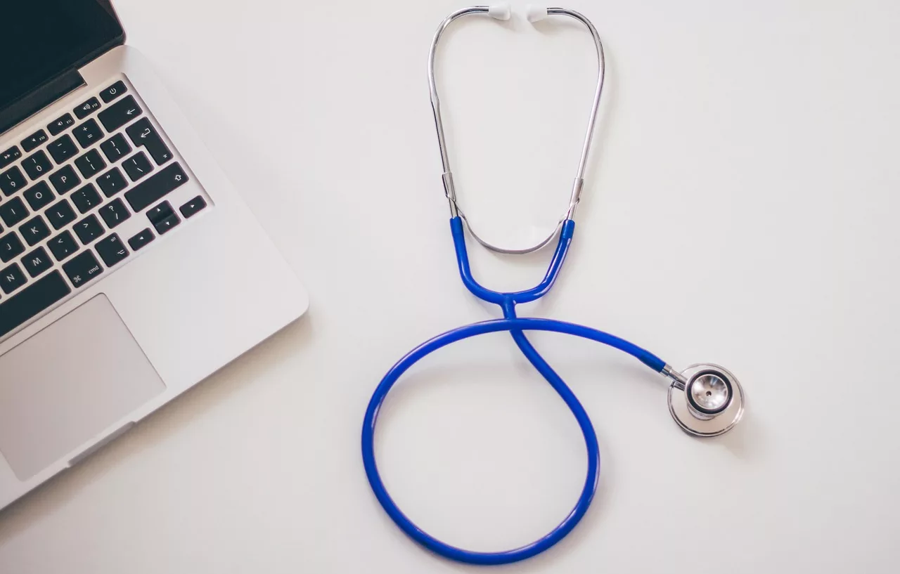 Stock photo of a stethoscope next to a laptop